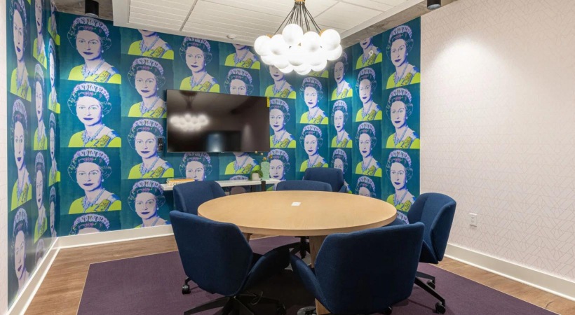 Settle into comfort at Connection at Southside a room with a table, a TV and chairs